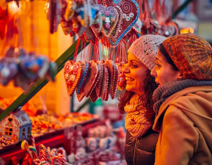 Friends Buying Candies On Christmas Market